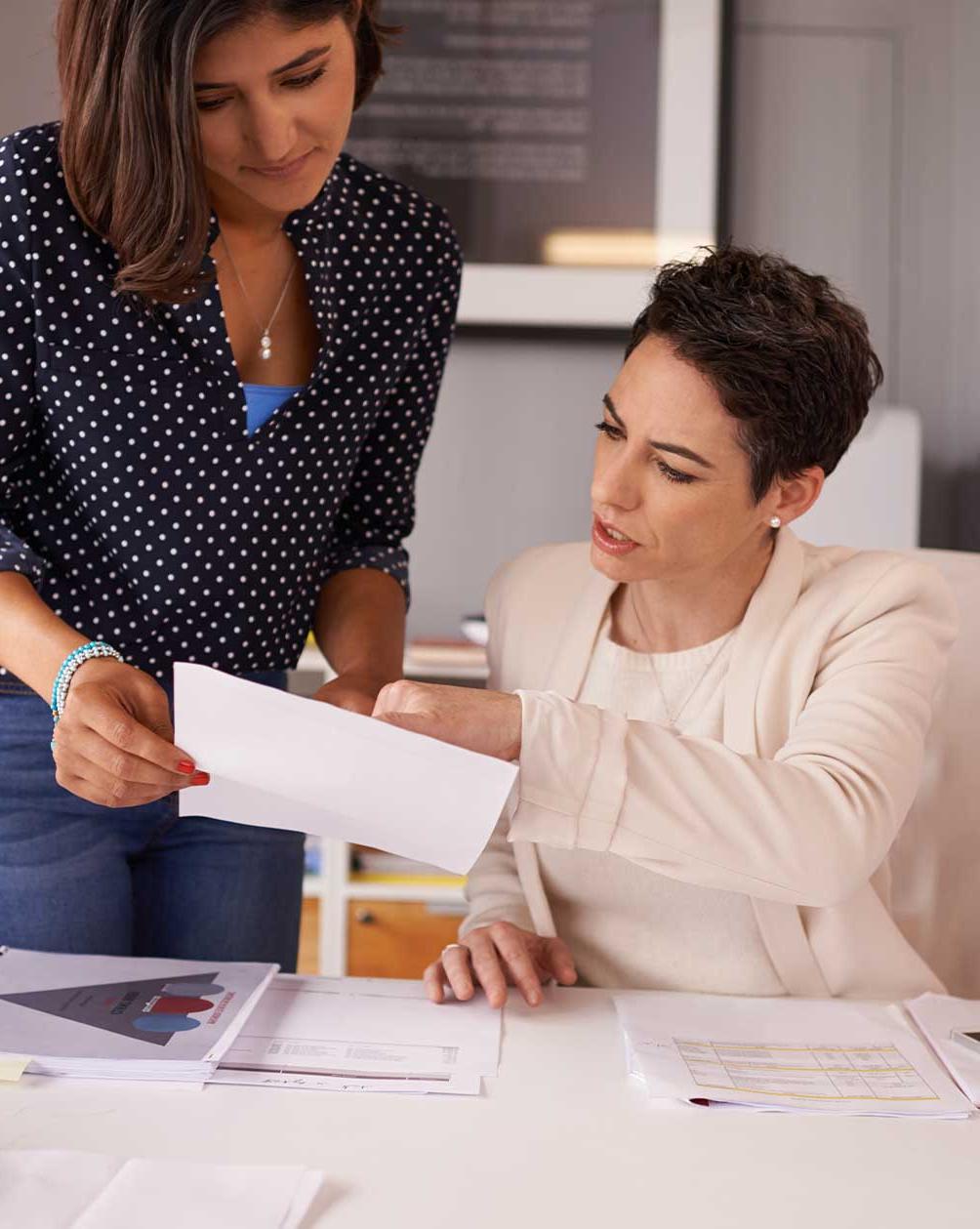 Women working in through reports together